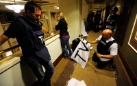 Members of the media mark white flags