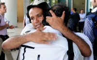 Members of the media embrace