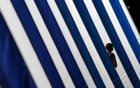 A woman walks into the Olympic stadium, 2012