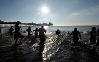 Swimmers run into the sea