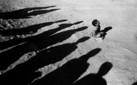 A young boy sits in a refugee camp. Afghanistan, 2001